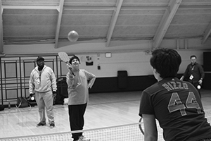 Paddle    Pals:  Returning a serve, junior Parsa Mir Heydari plays pickle ball with Eddie Brown, adaptive PE Leader. Adaptive PE leaders share similar responsibilities as other PE leaders. 