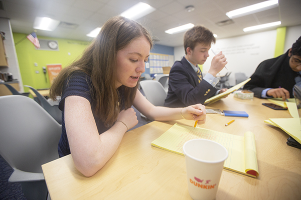 DEDICATED DELEGATES: Focusing on her work, Maddy McGrath, Model United Nations co-president,  helps a crisis staff respond to crisis notes during the GBSMUN conference. South’s MUN team hosted over 500 students for a conference on April 6. 