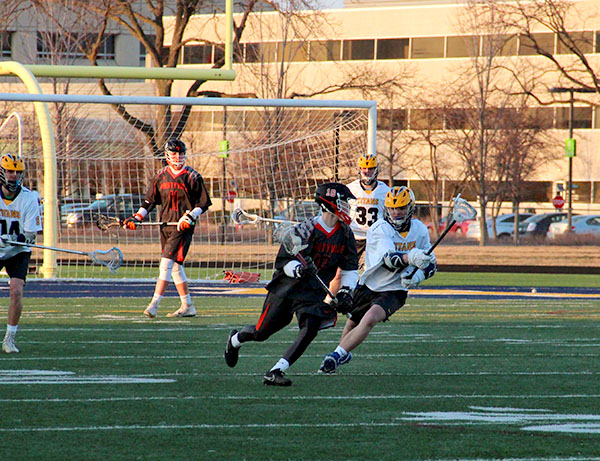 Sprinting after a Libertyville player, junior Justin Schuler defends the ball in a home game on April 2.