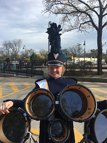 Booming with a smile at last year’s homecoming parade in downtown Glenview, Clare Dunne Murphy celebrates a successful performance with the marching band.  Photo courtesy of Claire Dunne Murphy