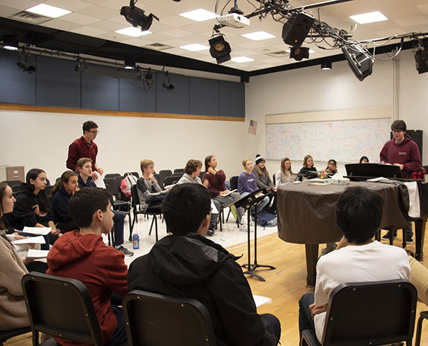 Teaching the youngsters: Helping middle schoolers learn a capella, seniors Ben Kalish (standing left) and Brian Destefano (standing right)    share their knowledge to make the transition into high school choir easier. The kids have an opportunity to prepare for South’s choir. 
