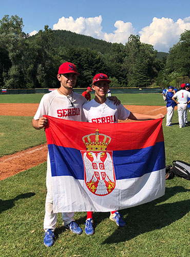 Smiling Sava: Posing with teammates, Sava Dupor (number 6) had a successful run of games in Sofia, Bulgaria over the summer. Dupor was recruited to the Serbian National Team as a pitcher by Coach George Grkinich after playing for the GBS baseball team last spring.