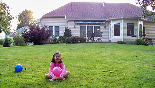 Sweet Carolina: Posing for the camera, Carolina, 5 years old, sits in New York, outside her fifth home. She moved two times after this, residing in a total of seven homes. Photo courtesy of Carolina Rodriguez