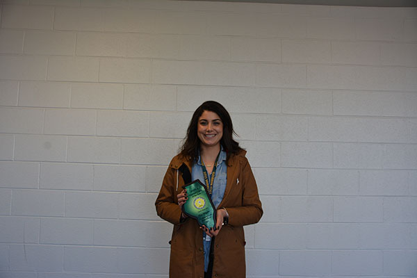 Awarding Ahlgrim: Holding her plaque after winning the Regional Head Coach of the Year Award, Meg Ahlgrim, varsity girls’ tennis head coach, expressed surprise at being chosen after only one year of coaching the team.