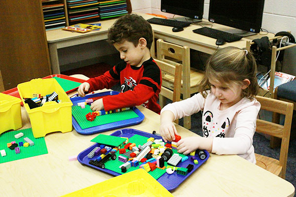 Toys AND Tots: Playing with LEGOs, two Titan Tots participate in their class time playing with toys.      South students have discovered passions for childhood education through through their experiences                 with Titan Tots. 