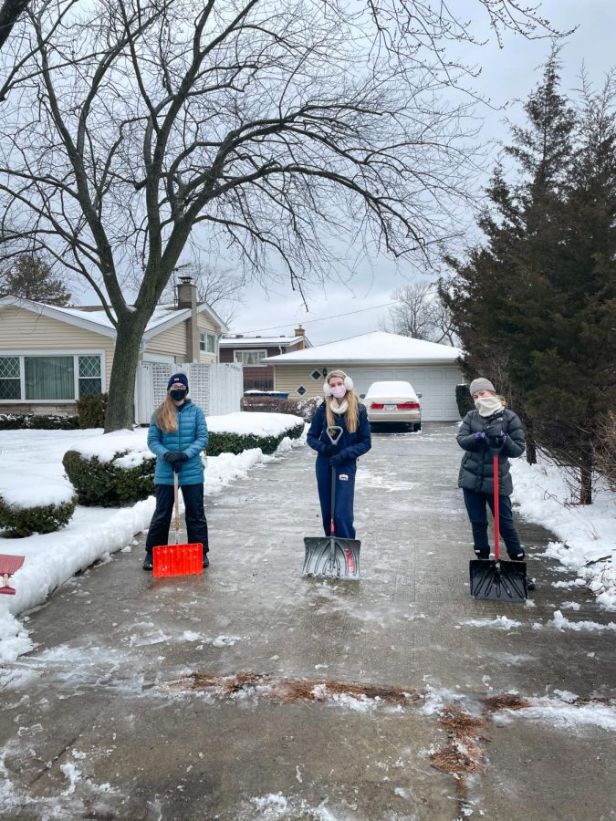 Sweet Students: Persevering through icy tempuratures and snow-covered driveways, juniors Elise Bauerschmidt, Elle Milek and Bella DeRosa (left to right) help out senior citizens through the Snow Angels Program. Photo courtesy of  Grace Cullum