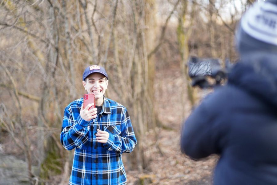 Shooting his comedic narrative, senior Ian Quiles smiles in front of the camera. The narrative was produced by seniors Quiles, Bri Pop and Ethan Mendoza. 