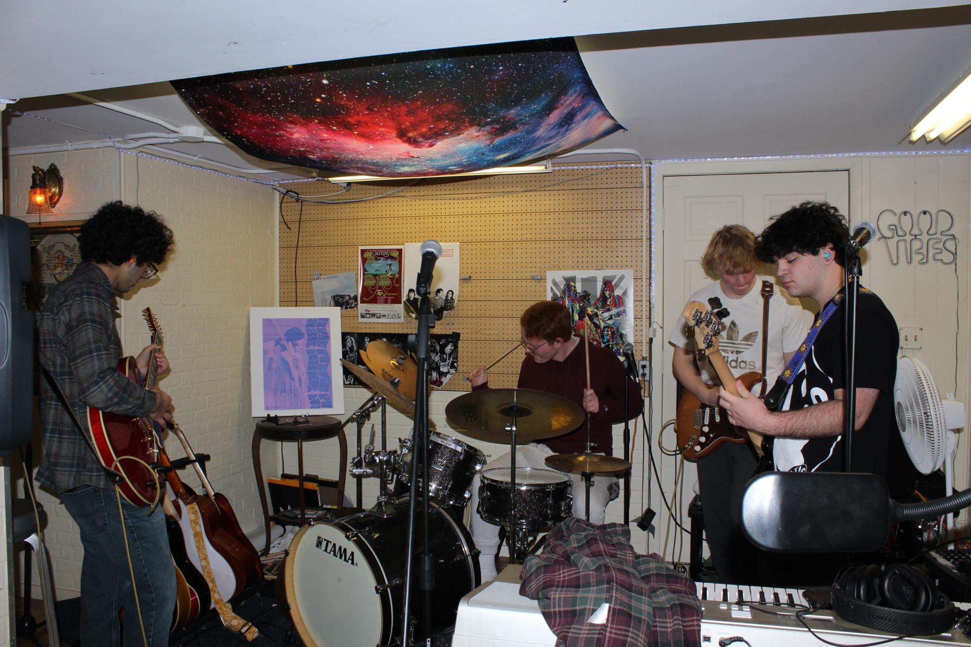 Jam Session: From left to right, seniors Borna Movaffaghi, Matthew Zelkowitz, Wyatt Anderson, and Isaac Bernstein practice an original song in Zelkowtiz’s basement. Left Turn 25 practices weekly for various performances.