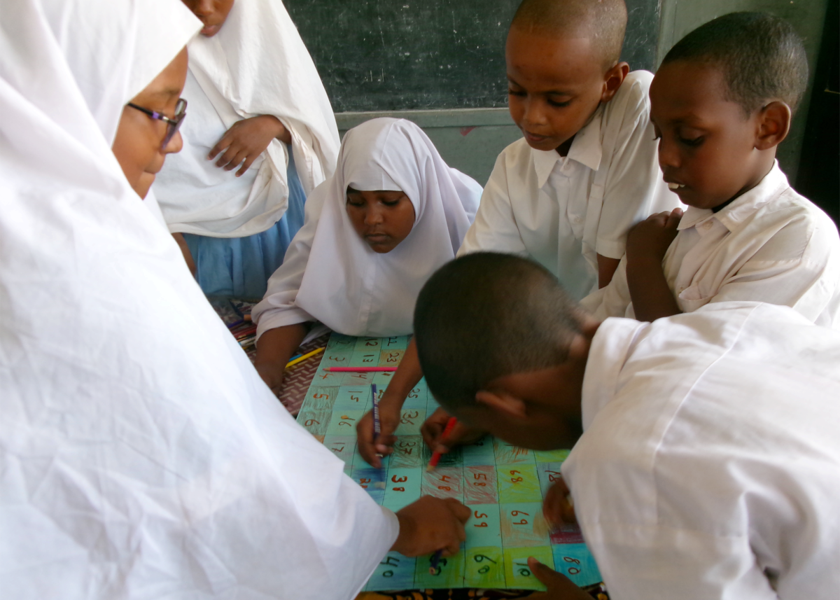 LEARNING TO LISTEN: Fourth graders from Mvita Primary School in Mombasa, Kenya, build math and public speaking skills through interactive games and a debate. 