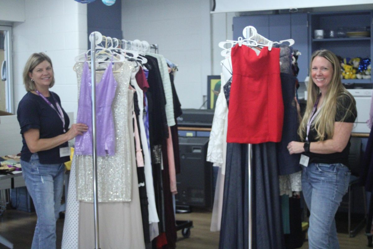 Helping Hands: Booster Club members, Dana Ward (left) and Jenny Gitelson (right), helped students buy clothes for homecoming. The shop was set up in the SAC, where students could pick out their outfits. 