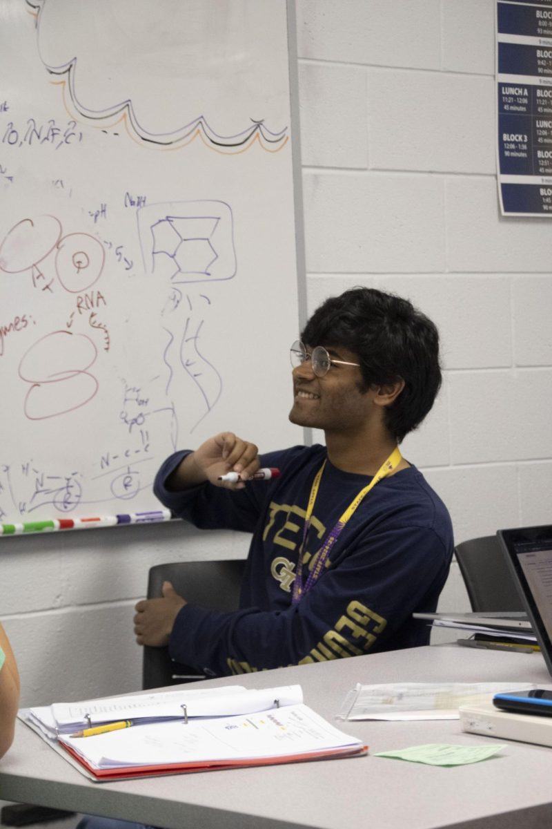 TUTORING TENACITY: TLC Tutor Anish Abeysiriwardena sat in the TLC, delivering a science lesson to students. These lessons are usually in biology, physics, and chemistry but at times change to other subjects.    