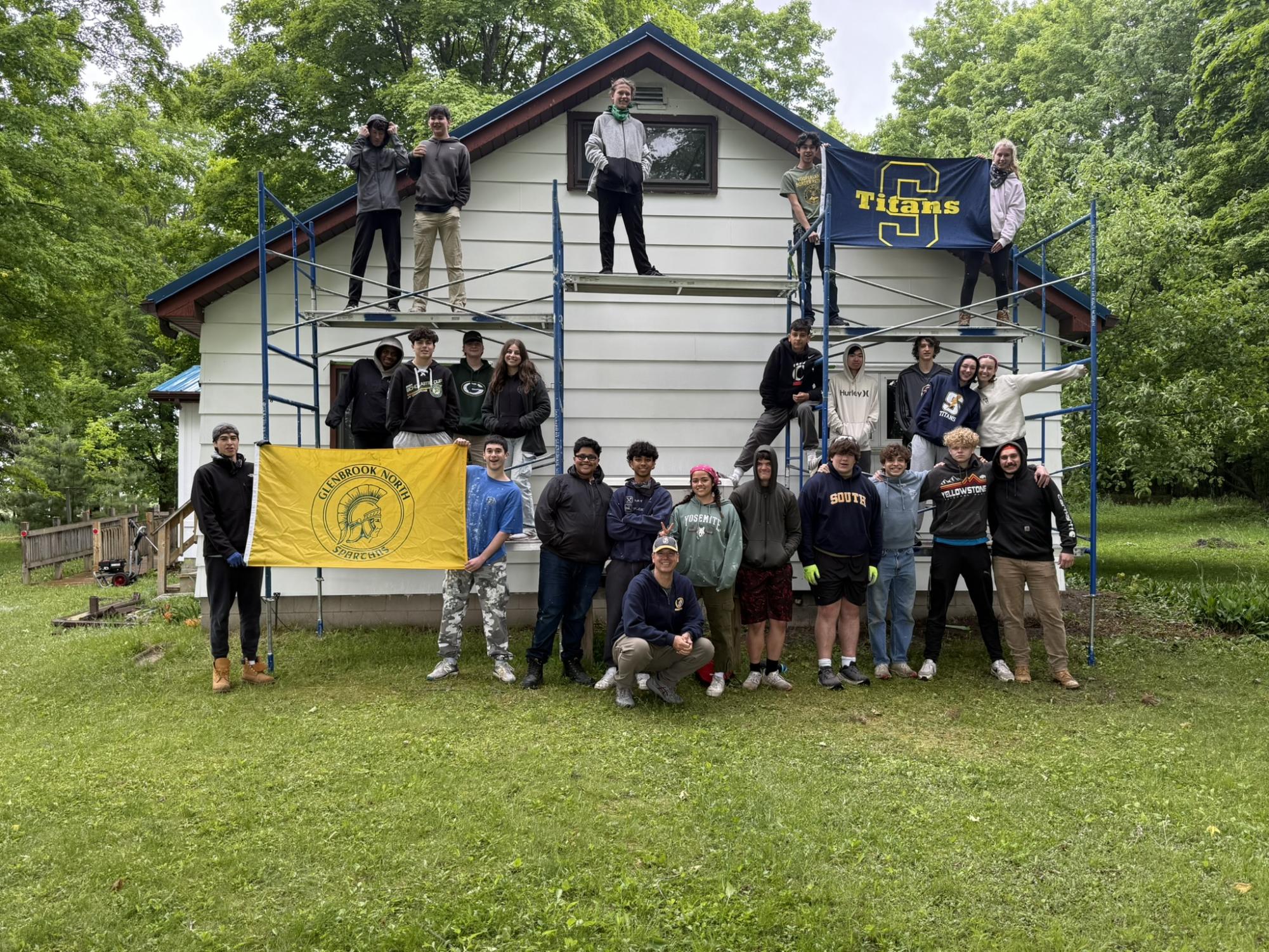 A WEEKLONG EFFORT: South and North students, along with accompanying teachers, pause outside the house they renovated from June 9 to June 14. Habitat for Humanity, offered as a summer school course, gave each student credit while gaining hands-on experience. Photo courtesy of Principal Dr. Barbara Georges
