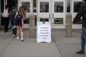 DOOR DETOUR:  On late arrival mornings, students are no longer allowed in the building as early as last year.  When a student attempts to enter the building before 9 a.m., they will be redirected to Door OO. 
Photo illustration by Ellory Moran. 