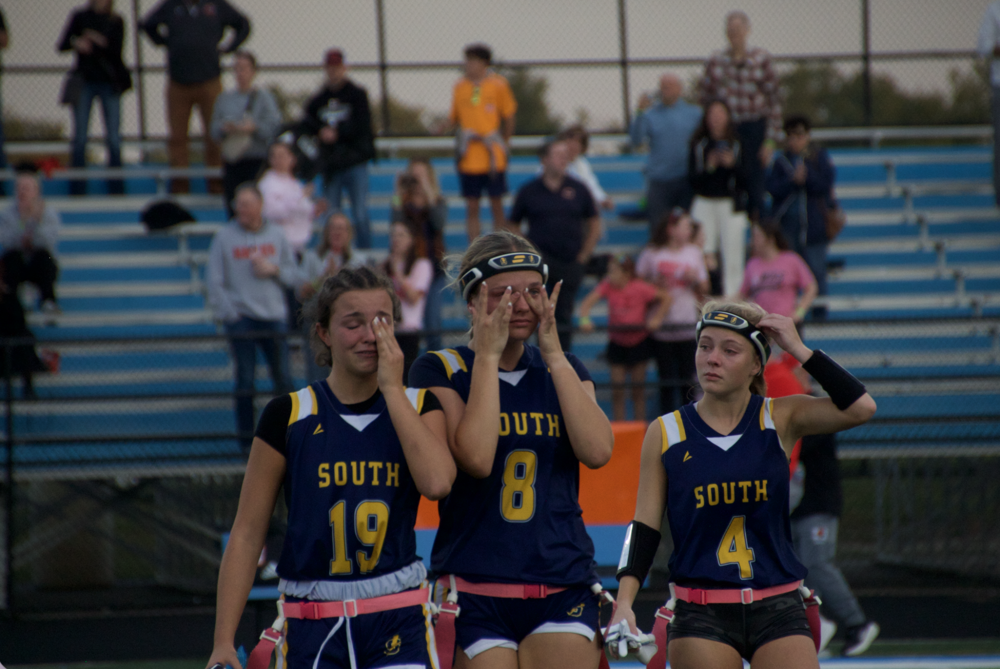 GAME FACE: At the State Semifinal against Maine South, seniors (left to right) Marissa Duri, Taylor Binney, and Jaima Devine, cope with the intense emotion of losing the match 20-0. Even though the game marked the end of their record season, they fought hard both physically and mentally. 