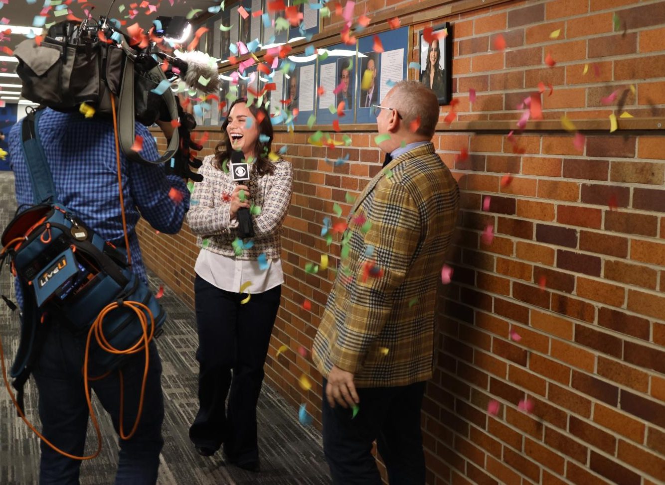 CBS SURPRISE: Dr. Mark Maranto, Assistant Principal of Student Activities, (right) announced Marissa Perlman, CBS News Chicago reporter, (middle) to be the 2025-2026 distinguished alumni on Nov. 20. Scott Wilson CBS News Chicago Team Lead Photographer, (left) captured Perlman’s surprised reaction on TV.