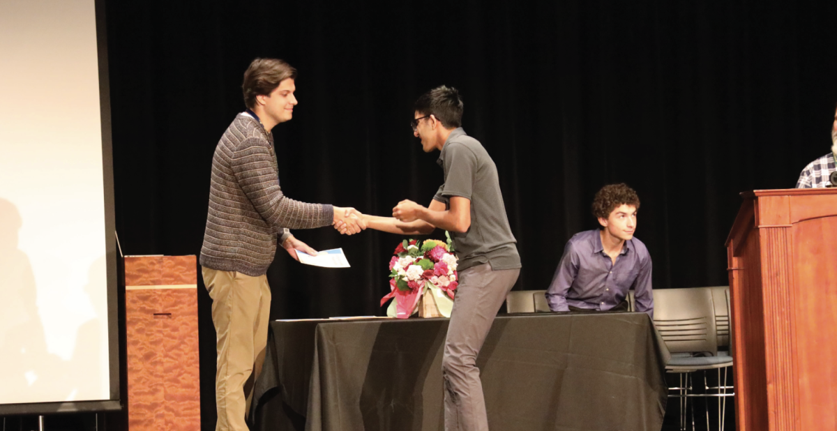 WELCOME TO THE CLUB: (Left) Brett Veitch, Math Teacher and Computer Science Honor Society
(CSHS) Adviser, welcomes Kamraan Kadakia, Senior and CSHS Vice President to the Honor Society. The
ceremony celebrated excellence specific to Computer Science classes.