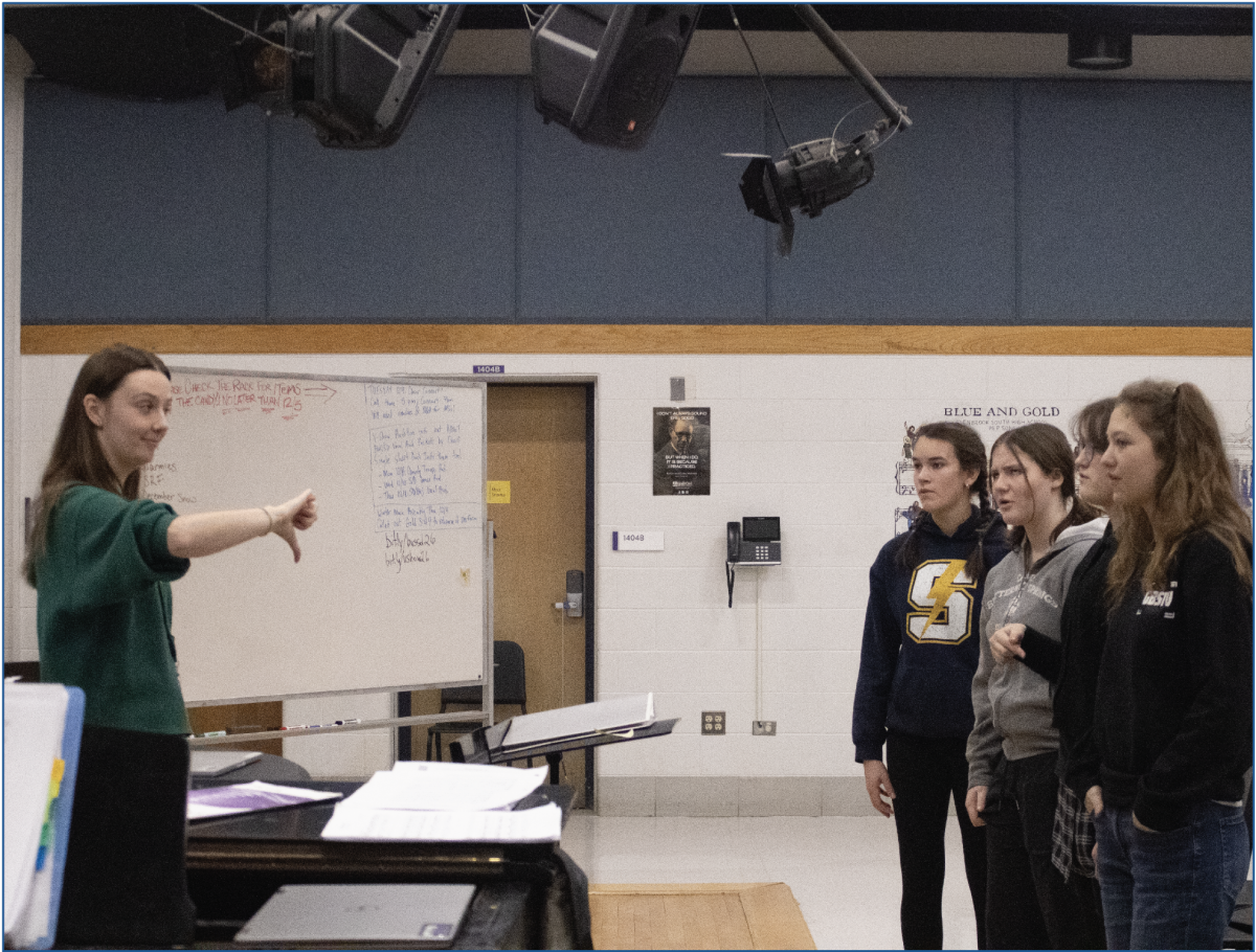 MUSIC MAGIC: Student teacher (left) Paulina Walczak helps Bel Canto, an auditioned choir, warm up with a major scale to prepare for rehearsal. Pictured left to right, sophomore Ella Sanders, junior Lily Fontana, junior Caroline Peters, and junior Sophia Shevitz watch Walczak carefully conduct.