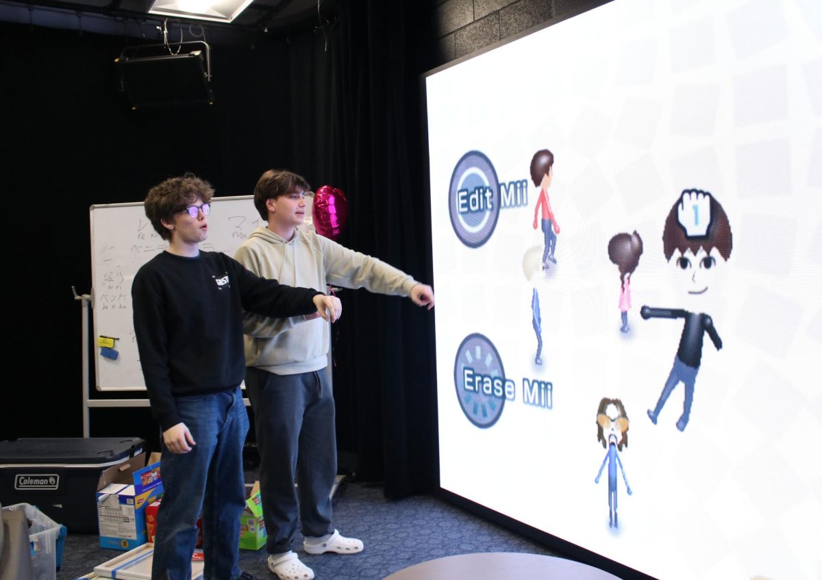 TV TOOL: Senior Brendan Schafer (left) and junior Brendan Long (right) work together to create a Mii, using the app Mii Channel through the Wii system, on the Alumni Video Wall during a break from recording V-Show. The wall is often used for working on TV projects and film festival submissions.