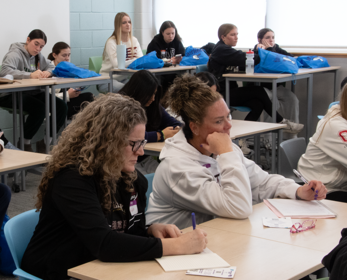 INSPIRING VOICES: Students and coaches sit attentively during the EmpowerHER conference on Feb.16,
listening and taking notes as speakers share insights on leadership and confidence. The conference brought
together female student athletes from multiple schools to learn, connect, and to believe in themselves, both in
athletics and beyond.