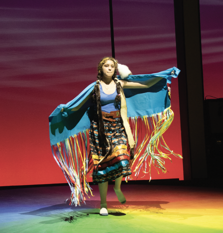 FLYING SOLO: Senior Maddie Ocampo extends her arms, draped with her
shawl, as she performs her dance, Fancy Shawl, a traditional Native American dance alone on stage. Ocampo participated in this year’s V-Show, themed “Kaleidoscope”, where she was the only act with a singular performer on stage throughout the entire show.