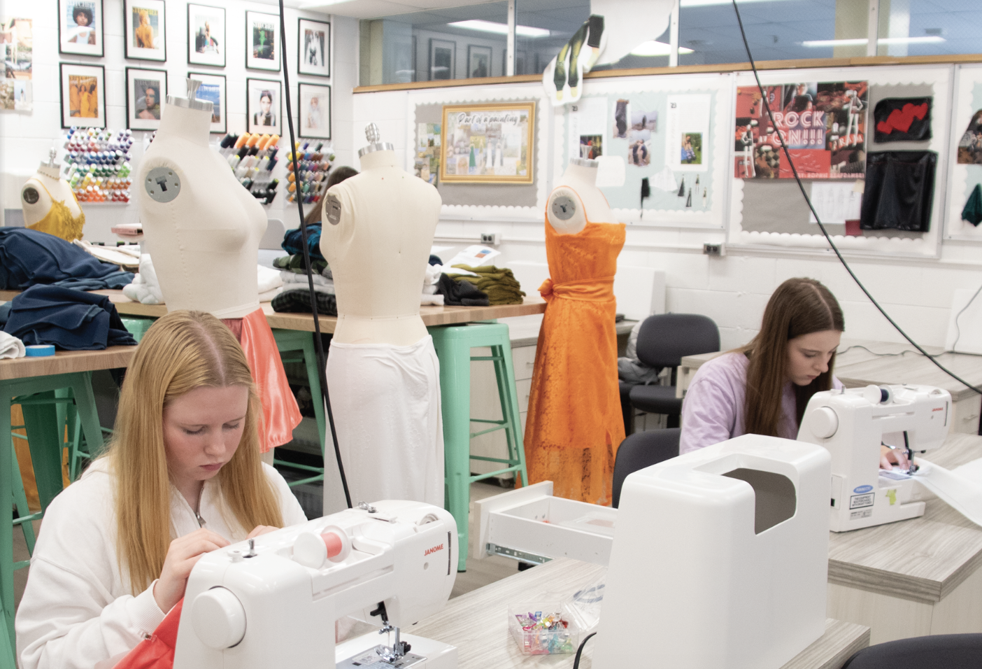 FASHION MASTERPIECES: Juniors Alina Dolgikh and  Sophia Hammer (left to right) work on their garments for the Fourth Annual Fashion Show, showcasing the skills they learned from South's Fashion Department. Sewing their clothes, they get ready to show off their hard work on May 19 on the fashion runway. 