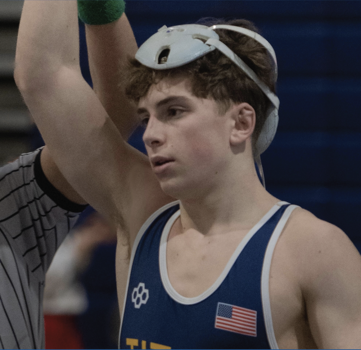 EDELHEIT TAKES THE WIN: Freshman Josh Edelheit lifts his arm in victory after winning a match during a meet against sophomore Sean Smylie from Loyola Academy. After three previous matches earlier that day, Edelheit finishes off the day with a win.