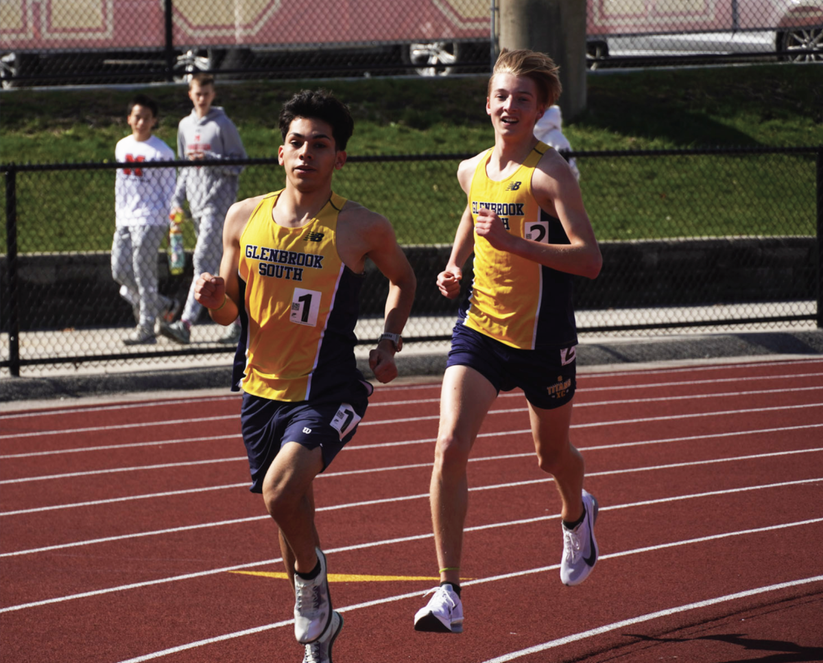 MOMENTS BEFORE MILESTONE: Senior Junior Lopez (left) and junior Frankie Hackl (right) ran at the Schaumburg Mikias Tibebu Invite on April 25. They were photographed moments before Hackl overtook Lopez for the new record. 