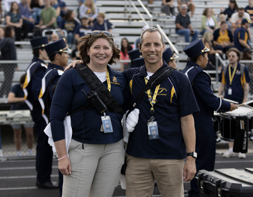 SPLINT SQUAD:  Megan Shipp, Assistant Athletic Trainer (left), and Anthony Catsaros, Head Athletic Trainer (right) stand on the sidelines at the first home football game of the season. They keep all eyes on the field, in case of possible injuries such as concussions, ankle sprains, or knee injuries.
