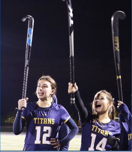STICK TOGETHER:  Senior Ella Millman (left) and sophomore Hallie Goldberg (right) are pictured at a game against Saint Ignatius High School. Although the team lost the game, they continue to keep their heads high. 