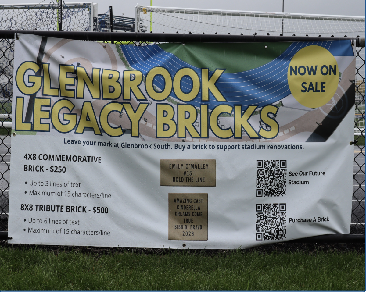 BRICKS BUILD MEMORY: A banner on the fence at the John David Titan Stadium advertises legacy bricks for people to buy and engrave. Buying a brick will help fund the stadium renovation and be displayed in the stadium’s path for purchasers to visit.