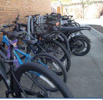 UPCOMING E-BIKE PROHIBITION: These e-bikes are sitting by the Titan Dome during school. Starting Jan. 1 e-bikes will be outlawed in certain areas in Illinois and Glenview. 