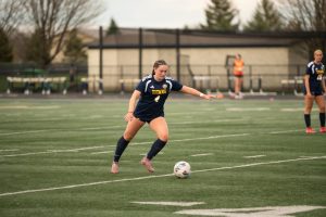 READY TO STRIKE: Senior Lyla Galat is pictured at a game against Fenwick High School. Galat is now committed for Division III.