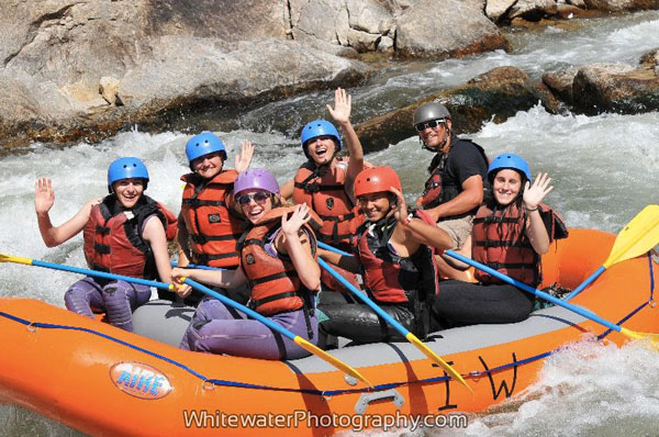 RAPIDS RAFTING: Rafting down a class IV rapids, students from different schools participate in a leadership activity at the JKB ranch in Colorado, including seniors Anastasia Athas and Sydney Kiwaiko. According to Kiwaiko, team communication was a necessity in this activity. 